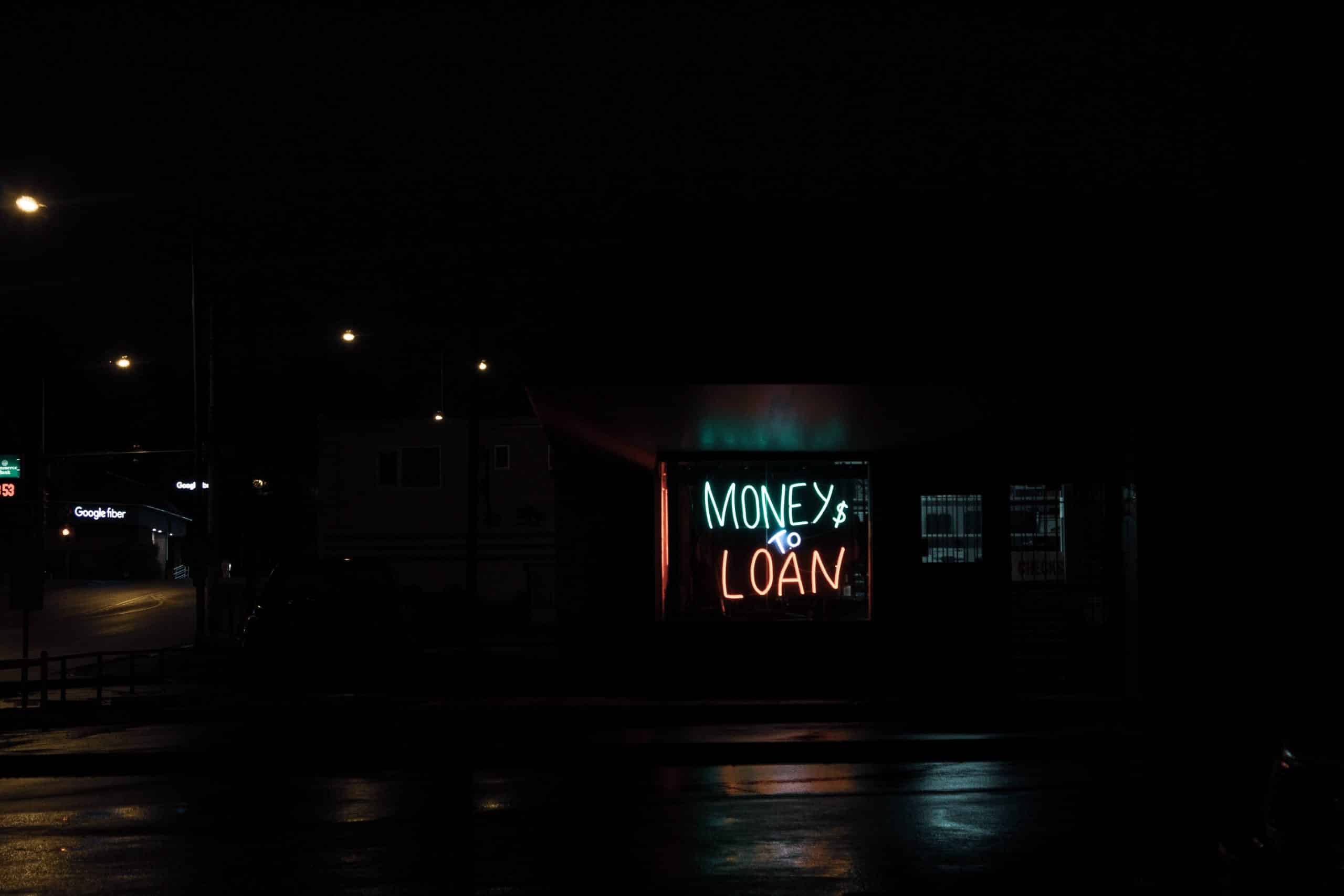 Money to loan sign at night